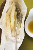 White asparagus cooked in foil, with fork