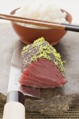 Raw tuna fillet with poppy seeds and lime zest, rice