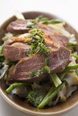 Duck breast on rice noodles with green asparagus