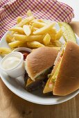 Cheeseburger, chips, mayonnaise, ketchup on plate