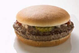 Hamburger with gherkin, onions and ketchup