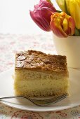 A piece of bee sting cake on plate with fork