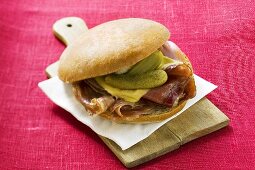 Bread roll with raw ham, cheese and gherkins
