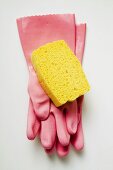 Pink rubber gloves and sponge