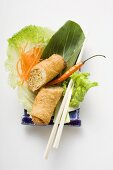 Spring roll, cut in half, on salad (China)