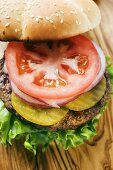 Home-made hamburger with gherkins, onions, tomato