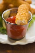 Fish finger with ketchup (a bite taken)
