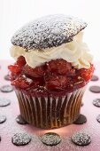 Chocolate cherry muffin with whipped cream and lid