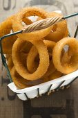 Deep-fried onion rings in a wire basket