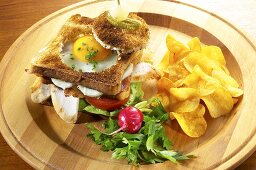 Club sandwich with chicken breast and fried egg