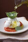 Drizzling insalata caprese with olive oil