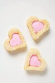 Three heart-shaped biscuits with pink icing