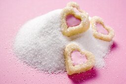 Heart-shaped biscuits on granulated sugar