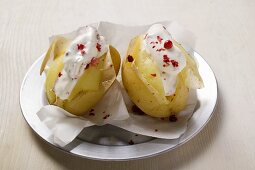 Potatoes cooked in their skins with sour cream & red pepper