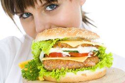 Young woman with giant hamburger