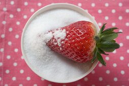 Strawberry in a bowl of sugar
