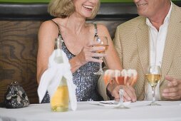 Mature couple with wine and shrimps in restaurant