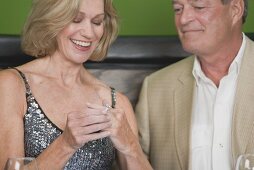 Mature woman happily trying on engagement ring