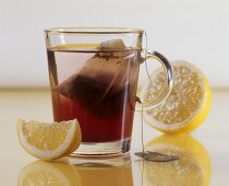 A glass of fruit tea with lemon