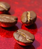 Coffee beans on red background