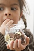 Girl eating chocolates out of a bag