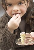 Girl biting into a chocolate