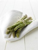 Green asparagus on white cloth