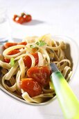 Linguine with cherry tomatoes in heart-shaped dish