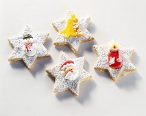 Star-shaped biscuits decorated with sugar figures
