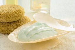 Cream in a shell, sponge and small bottle