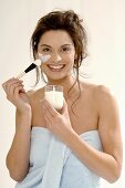Woman applying yoghurt mask