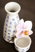 Sake flask (choshi) and cup (sakazuki) with orchid