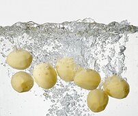 Peeled potatoes in boiling water