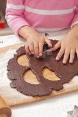 Girl cutting out biscuits