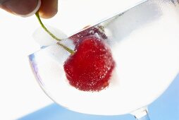 Fresh cherry in a glass of ice water