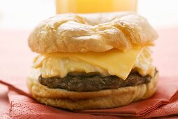 Cheeseburger with scrambled egg on napkin