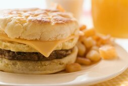 Cheeseburger with scrambled egg and fried potatoes