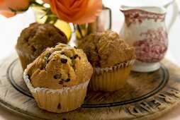 Assorted muffins on a wooden board