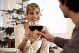 Young couple clinking glasses of red wine