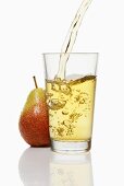 Pouring pear juice into a glass & pear