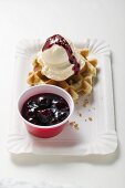 Waffle with vanilla ice cream and cherry sauce