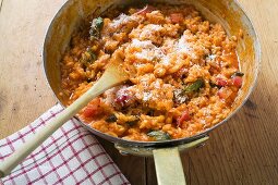Tomato risotto with basil and grated cheese