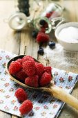 Fresh raspberries on a wooden spoon