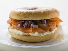 Salmon, cream cheese, onions and capers in a bagel