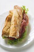 Sub sandwich with raw ham on a plate