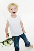 Laughing boy with bouquet of white roses