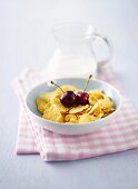 Cornflakes with milk and cherries for breakfast
