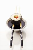 Futo maki with chopsticks and soy sauce