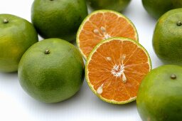 Whole tangerines and one halved tangerine