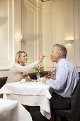 Mature couple enjoying dessert in a restaurant